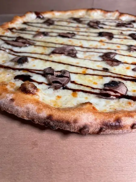 White sauce mushroom pizza finished with a balsamic drizzle
